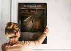 Une femme installe le poster encadré de Central Cee All Roads Lead Home sur un mur blanc.